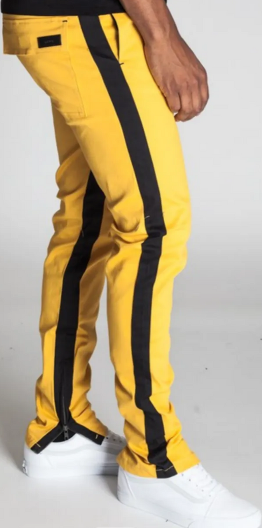 yellow pants with black stripes on the sides with zippers at the bottom ends