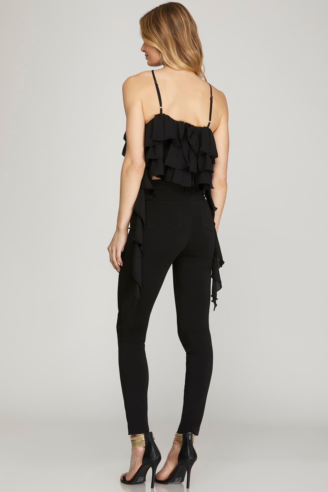 blouse features a halter neckline with ruffle