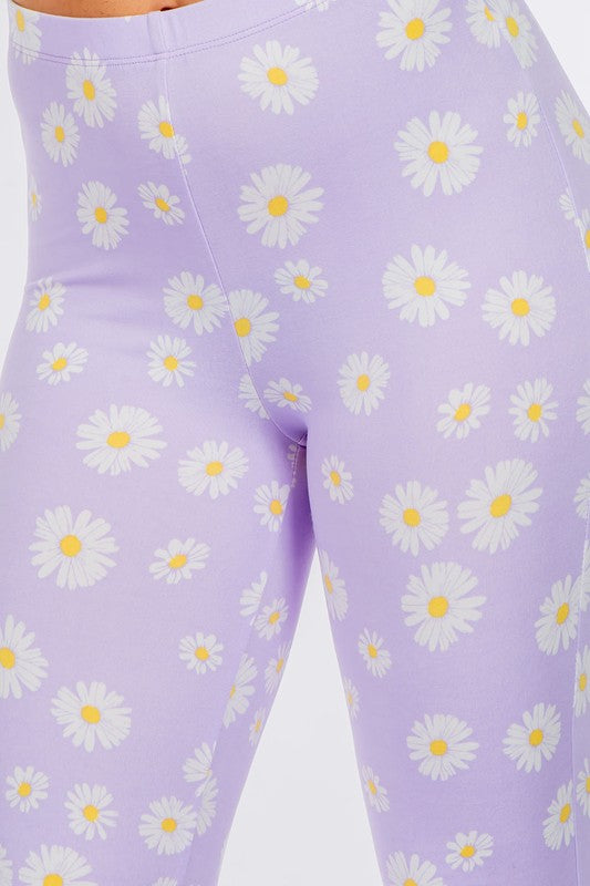 LONG FLARED PANTS WITH DAISY PRINT.IN BLACK.