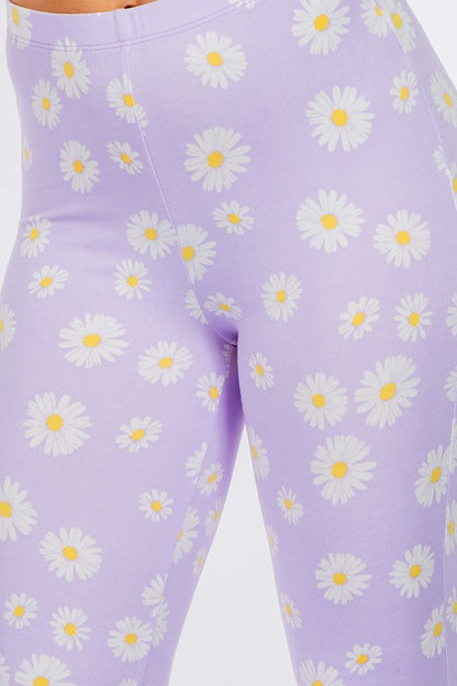 LONG FLARED PANTS WITH DAISY PRINT.IN BLACK.