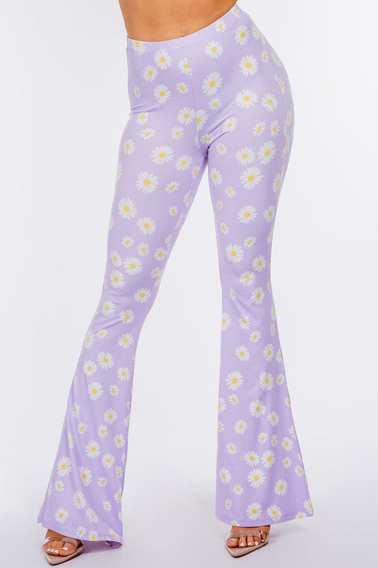 LONG FLARED PANTS WITH DAISY PRINT.IN BLACK.