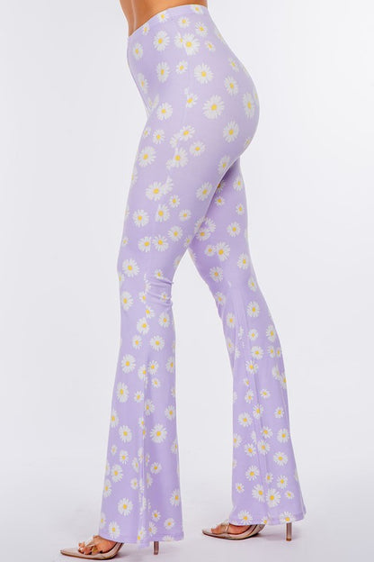 LONG FLARED PANTS WITH DAISY PRINT.IN BLACK.