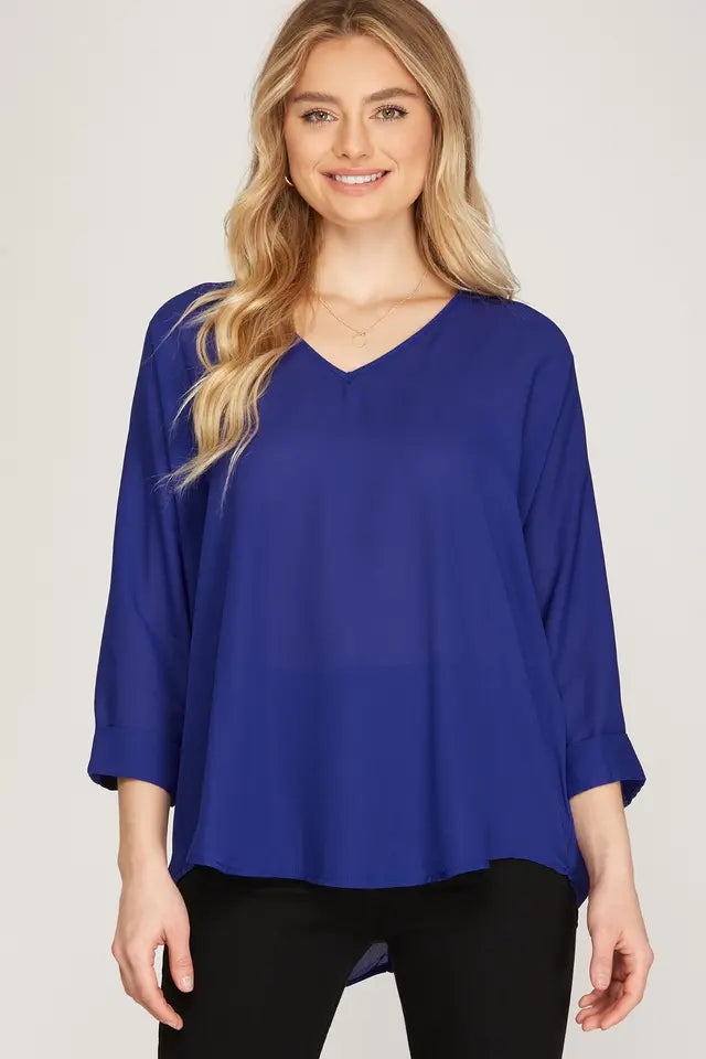 This 3/4 sleeve V-neck woven top, crafted from