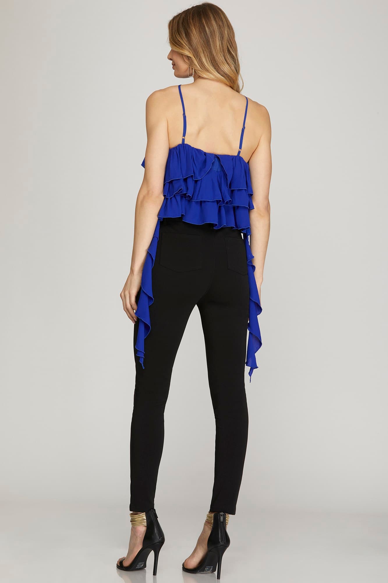 blouse features a halter neckline with ruffle